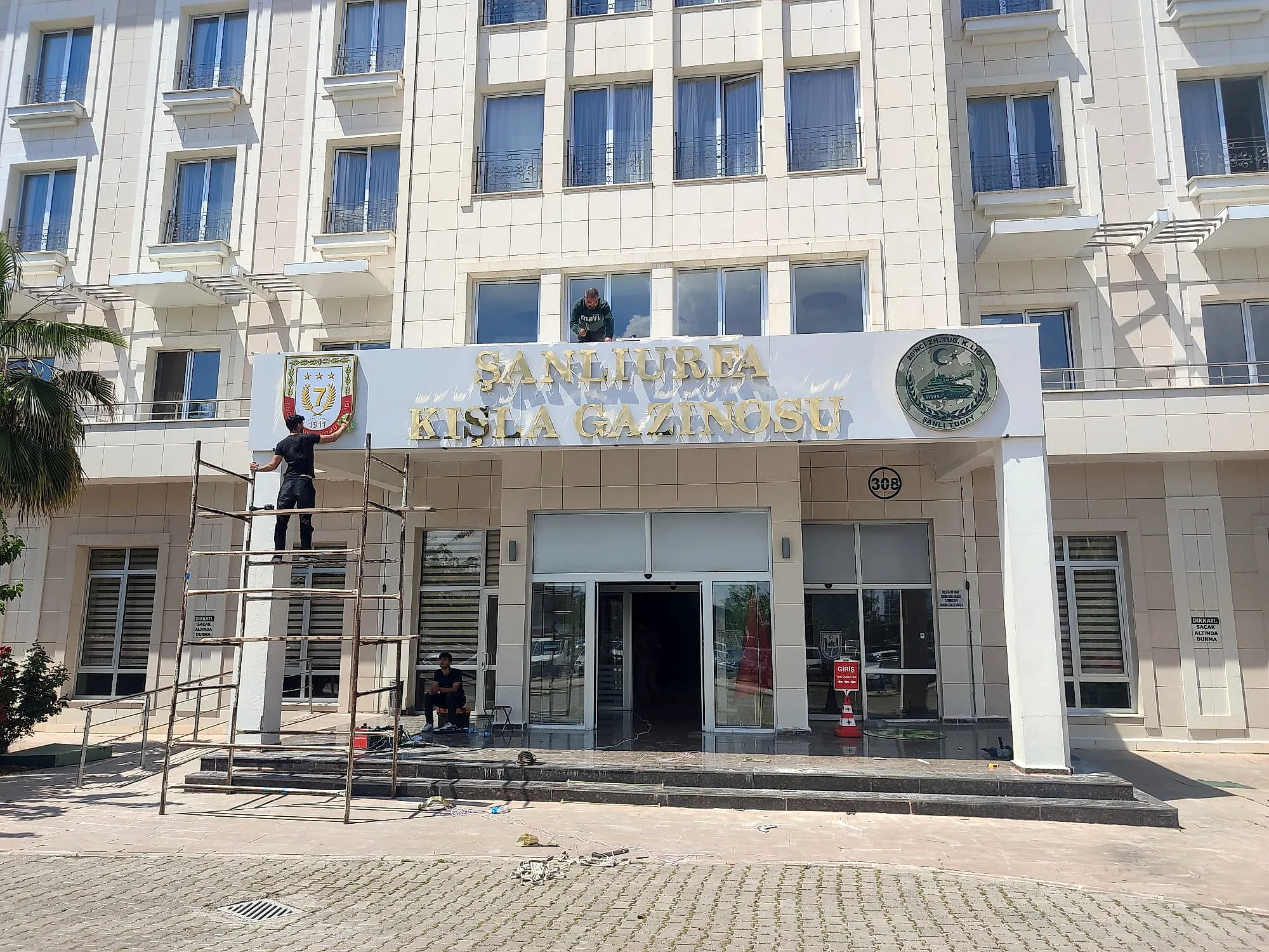 Montaj ekibi cephede krom harf takarken